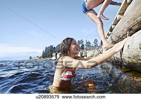 Teenage girls climbing pier View Large Photo Image Stock Photo - Teenage girls climbing pier. Fotosearch