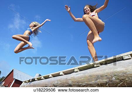 Teenage girls jumping into lake View Large Photo Image Stock Photograph - Teenage girls jumping into lake. Fotosearch