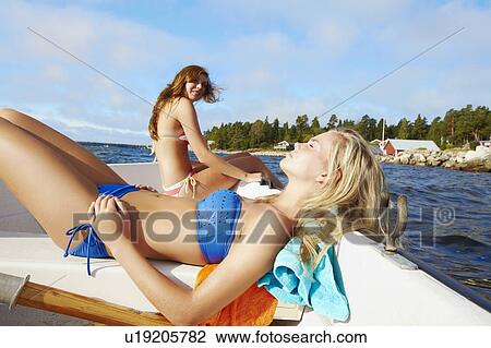 Teenage girls relaxing on sailboat View Large Photo Image Stock Image - Teenage girls relaxing on sailboat . Fotosearch
