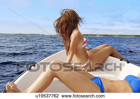 Teenage girls relaxing on sailboat View Large Photo Image Stock Image - Teenage girls relaxing on sailboat . Fotosearch