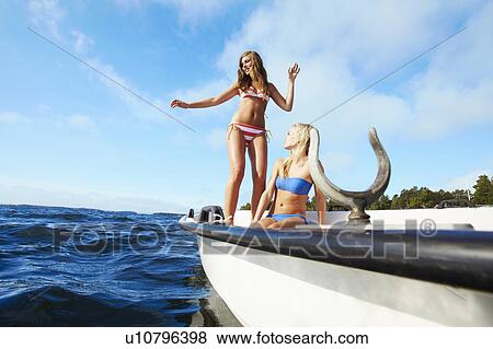 Teenage girls relaxing on sailboat View Large Photo Image Stock Photo - Teenage girls relaxing on sailboat . Fotosearch