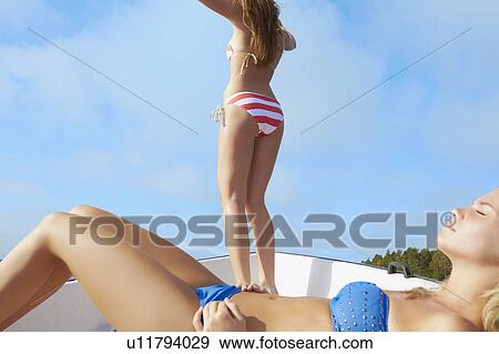 Stock Photo - Teenage girls relaxing on sailboat . Fotosearch