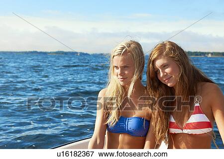 Teenage girls relaxing on sailboat View Large Photo Image Stock Photo - Teenage girls relaxing on sailboat . Fotosearch