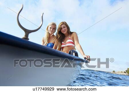 Teenage girls relaxing on sailboat View Large Photo Image Stock Photo - Teenage girls relaxing on sailboat . Fotosearch