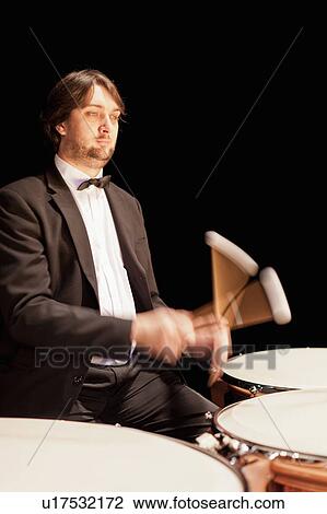 Stock Image - Timpani player in orchestra. Fotosearch