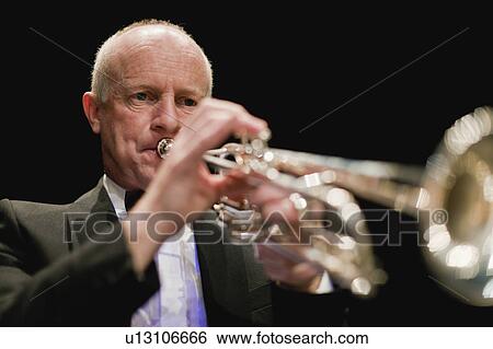 Stock Photograph - Trumpet player in orchestra. Fotosearch