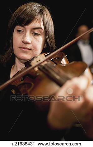 Stock Image - Violin player in orchestra. Fotosearch