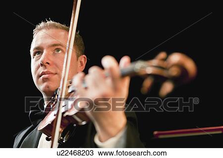Violin player in orchestra View Large Photo Image Stock Image - Violin player in orchestra. Fotosearch
