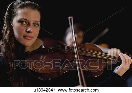 Stock Photo - Violin player in orchestra. Fotosearch