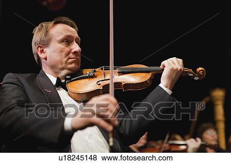 Stock Photo - Violin player in orchestra. Fotosearch