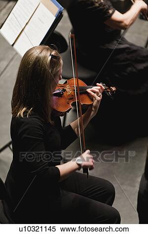 Stock Photography - Violin player in orchestra. Fotosearch