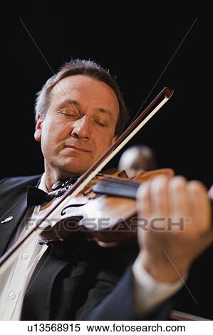 Stock Photography - Violin player in orchestra. Fotosearch