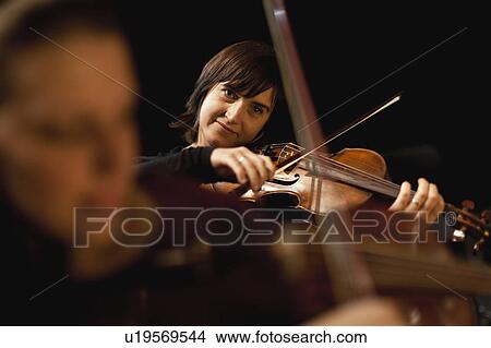 Picture - Violin players in orchestra. Fotosearch