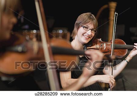 Violin players in orchestra View Large Photo Image Stock Photo - Violin players in orchestra. Fotosearch