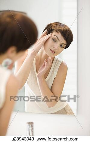 Woman admiring herself in mirror View Large Photo Image Stock Image - Woman admiring herself in mirror. Fotosearch