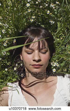 Woman asleep in tall grass View Large Photo Image Stock Photo - Woman asleep in tall grass. Fotosearch