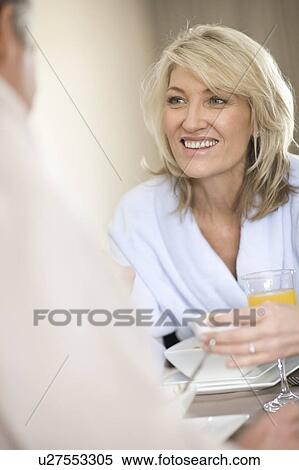 Stock Photography - Woman having breakfast with husband. Fotosearch