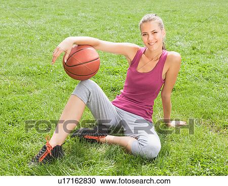 Woman holding basketball on grass View Large Photo Image Stock Image - Woman holding basketball on grass. Fotosearch