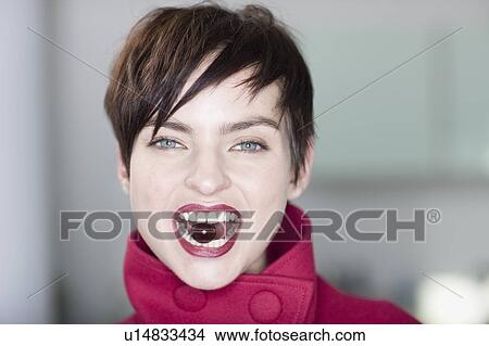 Woman holding grape between her teeth View Large Photo Image Picture - Woman holding grape between her teeth. Fotosearch