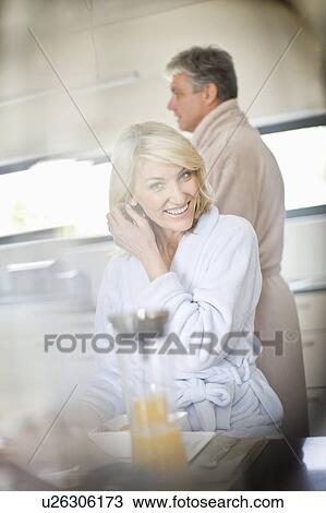 Woman in bathrobe at breakfast table View Large Photo Image Stock Image - Woman in bathrobe at breakfast table. Fotosearch