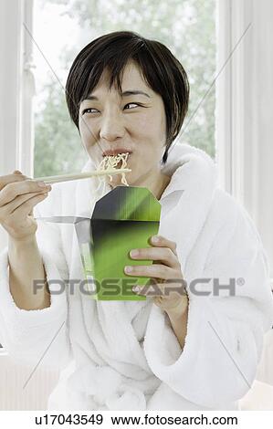 Woman in bathrobe eating Chinese food View Large Photo Image Stock Photo - Woman in bathrobe eating Chinese food. Fotosearch