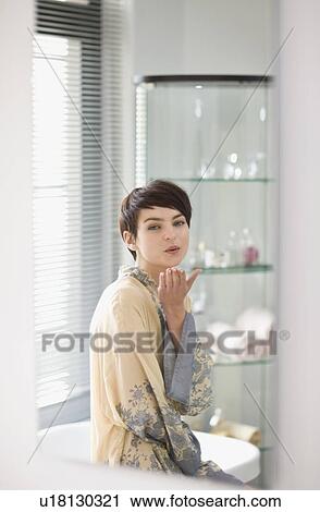 Woman in robe blowing kiss View Large Photo Image Stock Image - Woman in robe blowing kiss. Fotosearch