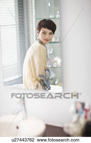 Woman in robe sitting in bathroom View Large Photo Image Stock Image - Woman in robe sitting in bathroom. Fotosearch