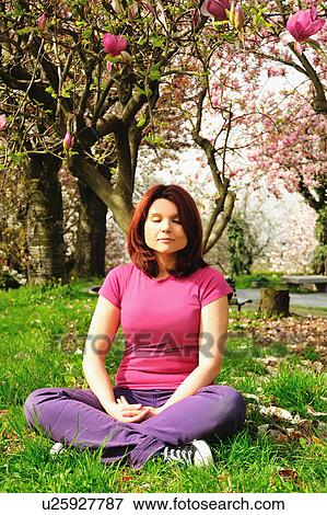 Woman meditating under blossoming tree View Large Photo Image Stock Photo - Woman meditating under blossoming tree. Fotosearch