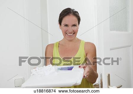 Woman offering wrapped present View Large Photo Image Picture - Woman offering wrapped present. Fotosearch