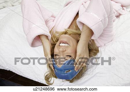 Woman on bed with eye mask on forehead View Large Photo Image Stock Photograph - Woman on bed with eye mask on forehead. Fotosearch