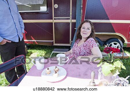 Woman picnicking outside trailer View Large Photo Image Stock Image - Woman picnicking outside trailer. Fotosearch