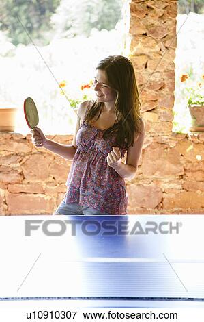 Stock Photo - Woman playing table tennis. Fotosearch