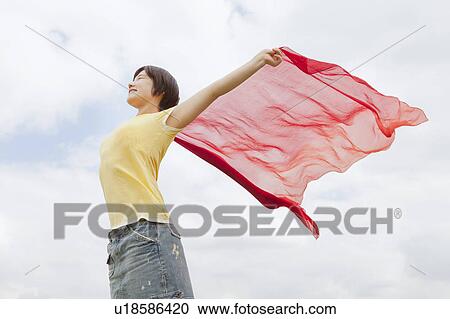 Woman playing with shawl outdoors View Large Photo Image Stock Image - Woman playing with shawl outdoors. Fotosearch