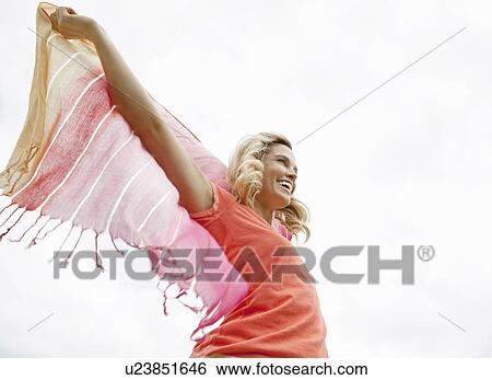 Stock Photograph - Woman playing with shawl outdoors. Fotosearch