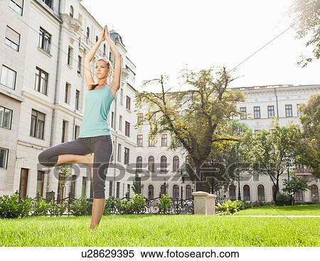 Woman practicing yoga in urban park View Large Photo Image Stock Photography - Woman practicing yoga in urban park. Fotosearch