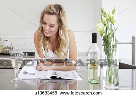 Woman relaxing with wine and magazine View Large Photo Image Stock Photo - Woman relaxing with wine and magazine. Fotosearch