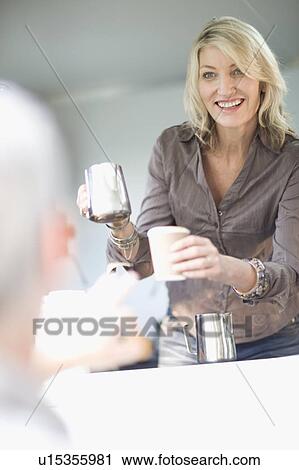 Woman serving coffee in food cart View Large Photo Image Stock Image - Woman serving coffee in food cart. Fotosearch