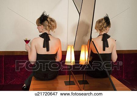 Woman sitting on table in bar View Large Photo Image Stock Photo - Woman sitting on table in bar. Fotosearch