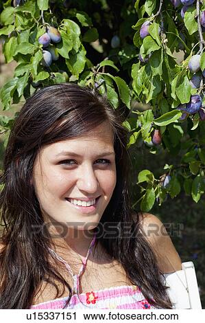 Woman smiling by fruit tree View Large Photo Image Stock Image - Woman smiling by fruit tree. Fotosearch