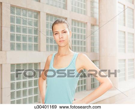 Woman standing on city street View Large Photo Image Stock Photo - Woman standing on city street. Fotosearch