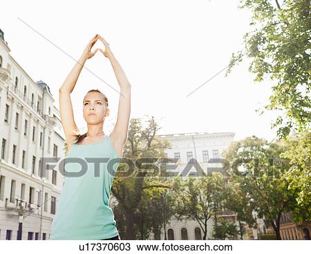 Woman stretching in urban park View Large Photo Image Stock Image - Woman stretching in urban park. Fotosearch