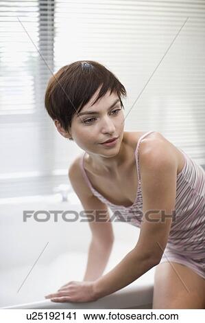 Stock Image - Woman testing bathwater. Fotosearch