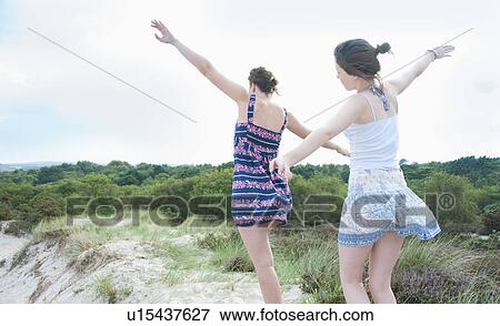 Women playing airplane on beach View Large Photo Image Stock Photo - Women playing airplane on beach. Fotosearch