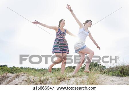 Women playing airplane on beach View Large Photo Image Stock Photo - Women playing airplane on beach. Fotosearch