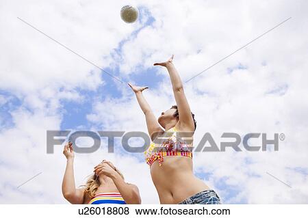 Stock Photo - Women playing with ball outdoors. Fotosearch