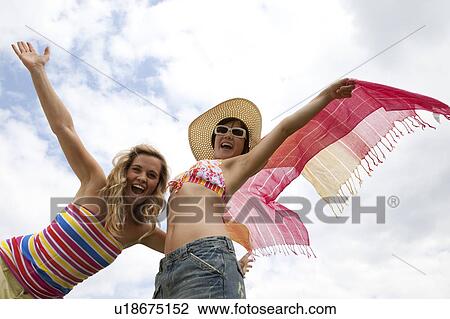 Women standing with arms outstretched View Large Photo Image Stock Image - Women standing with arms outstretched. Fotosearch
