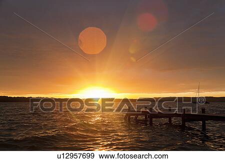 Wooden dock stretching into lake View Large Photo Image Stock Photo - Wooden dock stretching into lake. Fotosearch