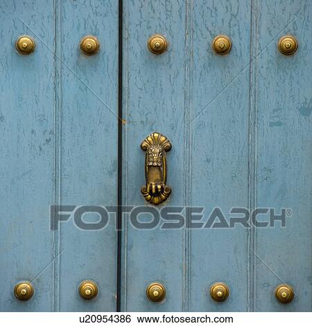 Stock Photograph - A Blue Door With Brass Decorative Knobs; Cusco Peru. Fotosearch