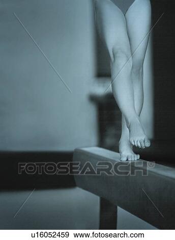 Stock Photo - A Gymnast Performing On The Balance Beam. Fotosearch