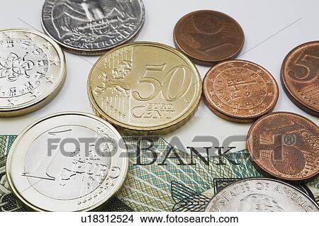 American And Euro Coins On Top Of A Foreign Currency Bank Note View Large Photo Image Picture - American And Euro Coins On Top Of A Foreign Currency Bank Note. Fotosearch